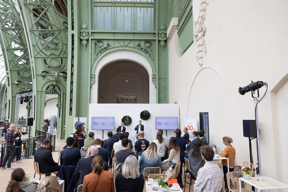 Conference at the ChangeNOW event, with two speakers discussing on stage in front of an audience.