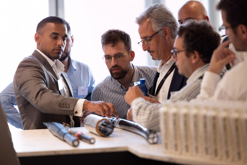Group of professionals discussing cables at a the Nexans Suppliers Day 2025