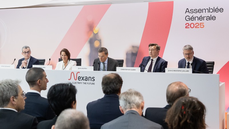 Panel discussion at a corporate event with audience members in the foreground.